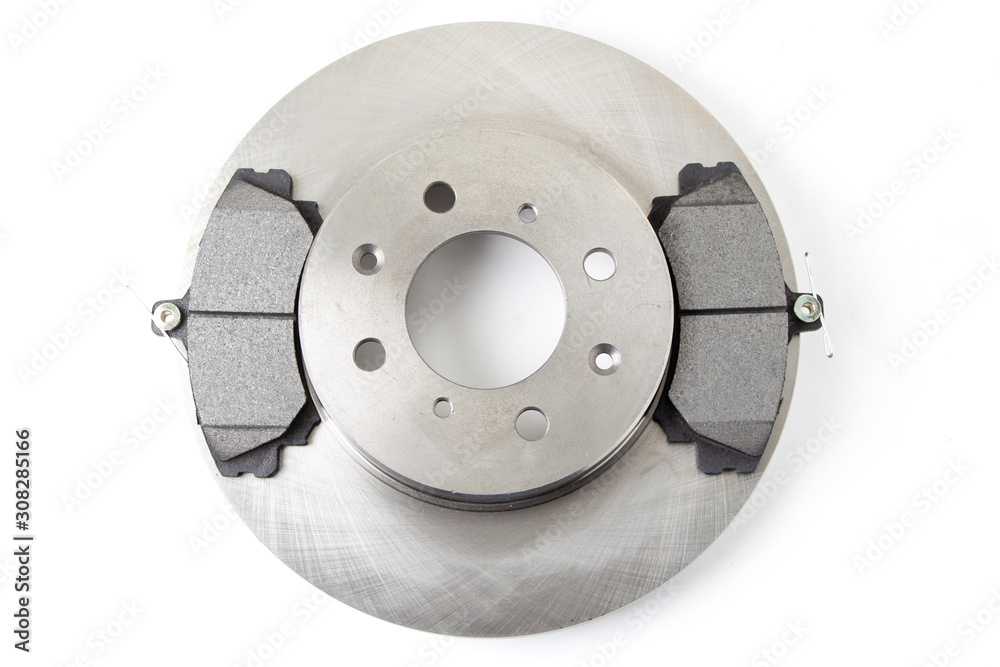 Brake pads and brake discs for cars isolated on white background. New car parts.
