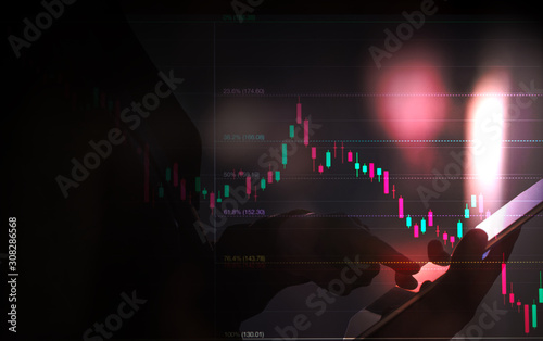 Fotomural business man or stock trader analyzing stock graph chart by fibonacci indicator,