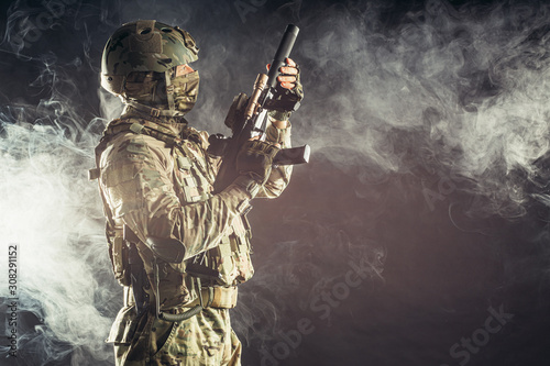 Fotomural young military, soldier man holding gun wearing military wear, green camouflage