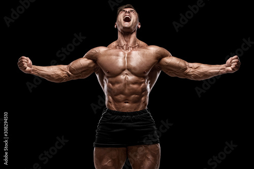 Cuadros en Lienzo Muscular man showing muscles isolated on the black background
