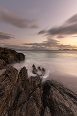 Beautiful exposure long in a rocky beach at sunset, sunrise, with a cloudy sky in San Vicente do Mar, A Lanzada, O Grove, Sanxenxo, Pontevedra, Galicia, Spain.