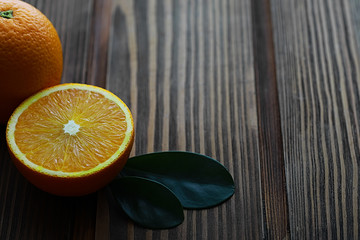 Orange citrus fruit on a stone table. Orange background.