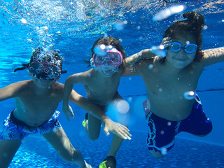 Kids enjoying in pool underwater