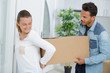 © auremar - young couple carrying box into appartment