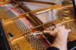 Man tuning traditional upright piano for jazz. hand of a man tuning piano, close up