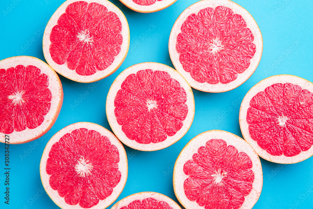 Fresh cut grapefruit on color background
