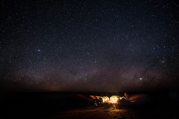 Sticker - Camping place with a bonfire and the breathtaking view of starry sky in the background