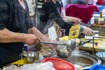 Local turnip cake vendor in Taichung Second Public Market. Old market has always been the favorite of backpack travellers, especially because of the food. Taichung, Taiwan