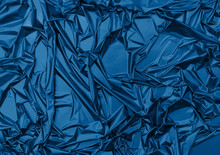 Shiny Crumpled Surface Of Trendy Blue Foil For Textured Holiday Background. Color Of The Year 2020 Concept. Backdrop For Your Design.