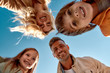© Svitlana - Playing together. Bottom view of happy and positive family smiling at camera while standing outdoors