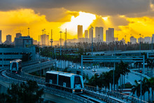 City Skyline At Sunrise With The MIA Mover, An Automated People Mover System At Miami International Airport Designed To Quickly Transport Land Side Passengers.