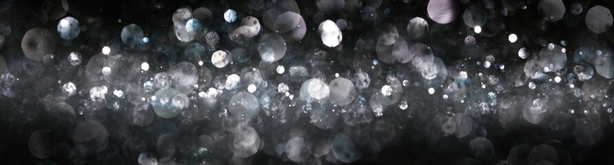 Wall Mural - Blurry bokeh of shiny silver lights and glitter abstract