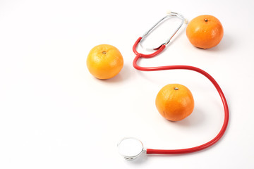 Orange Fruit with Red Stethoscope on white