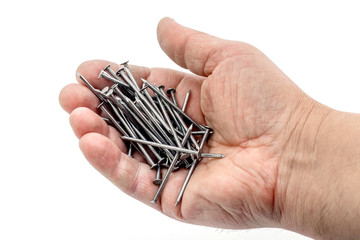 Wall Mural - Man holding construction nails in his hand on a white isolated background_