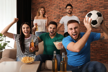 Wall Mural - Group of friends watching football at home