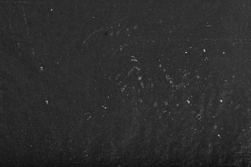 Black dusty abstract background. Old black film paper texture. Grungy textured blackboard.