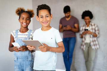 Wall Mural - Happy african american family using technical devices, phone. tablet