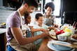 © NDABCREATIVITY - Happy family in the kitchen having fun and cooking together. Healthy food at home.