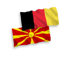 National vector fabric wave flags of North Macedonia and Belgium isolated on white background. 1 to 2 proportion.