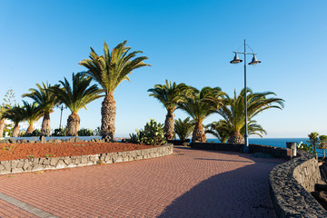 Wall Mural - Playa Blanca resort famous winding coastal promenade along Atlantic Ocean shoreline. Lanzarote, Canaries Islands, Spain.