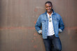 © elnariz - Stylish fashion casual dressed African American male, trendy jeans jacket, happy and cheerful pose