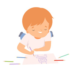 Wall Mural - Smiling Boy Lying on his Stomach and Drawing Picture with Colorful Pencils, Cute Young Artist Cartoon Character, Kids Creative Hobby Vector Illustration