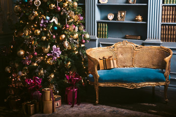 Christmas tree in the room near the fireplace and home library, the Christmas mood with gifts