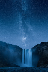 Waterfall at night under a beautiful milky way