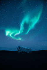 Wall Mural - Plane wreck at night and an epic aurora and stars on the sky