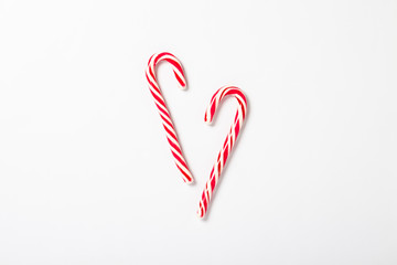 Wall Mural - Candy caramel cane on a white background. Concept Christmas, New Year, minimalism. Flat lay, top view