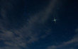 Christmas star rising in North Carolina with light clouds in the night sky. 