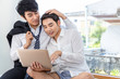 © Suthiporn - Romantic and relax time.Asian homosexual couple in suite shopping online with laptop computer together at home.Concept LGBT gay.