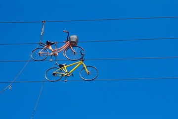 Extreme bikes are on a string in the blue sky, selectively focused