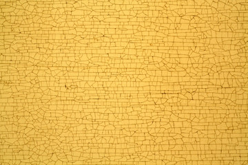 Yellow color cracks on metal texture.