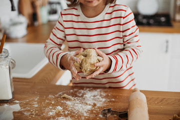 Wall Mural - 4 years cute girl making traditional Christmas cookies.