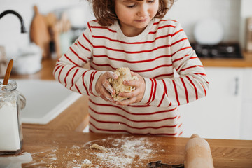 Wall Mural - 4 years cute girl making traditional Christmas cookies.