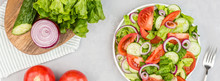 Healthy Vegetarian Dish On Table, Vegetable Salad With Fresh Tomato, Cucumber, Lettuce, Red Onion On Gray Concrete Background. Diet Menu. Top View. Flat Lay, Mockup, Template