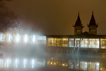 Canvas Print - The steamy Heviz spa at night. This pond is the largest natural warm watered thermal lake in the world for bathing.