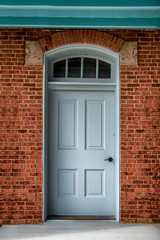 Wall Mural - Blue door on a brick building