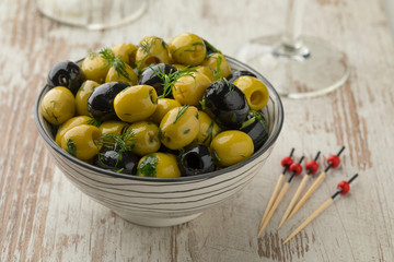 Bowl with green and black olives close up