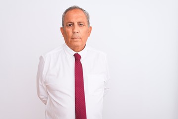 Sticker - Senior grey-haired businessman wearing elegant tie over isolated white background Relaxed with serious expression on face. Simple and natural looking at the camera.