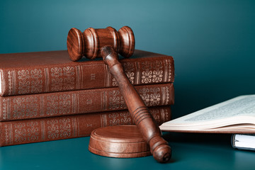 Close up of a brown wooden gavel and book