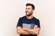 © luismolinero - Young handsome man with beard over isolated background happy and smiling