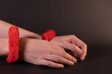 Girl's hands in handcuffs on a black background