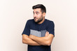 © luismolinero - Young handsome man with beard over isolated background making doubts gesture while lifting the shoulders