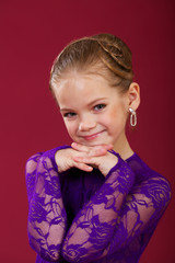 Wall Mural - Portrait of a little girl in a purple dance dress