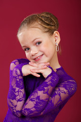 Wall Mural - Portrait of a little girl in a purple dance dress