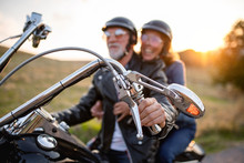 Cheerful Senior Couple Travellers With Motorbike In Countryside.