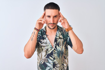 Canvas Print - Young handsome man wearing Hawaiian summer shirt over isolated background with hand on head for pain in head because stress. Suffering migraine.