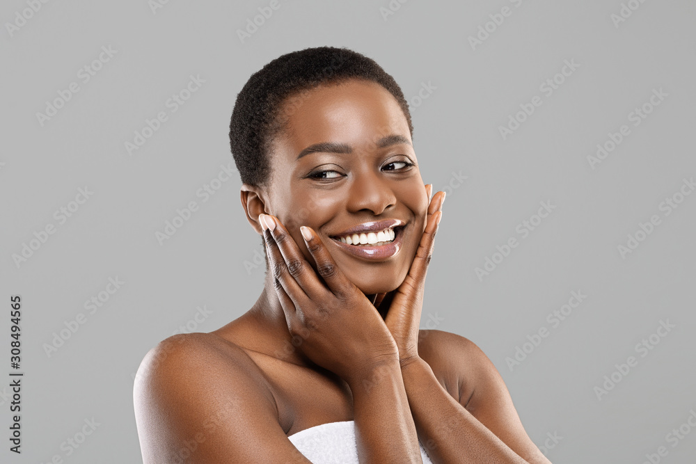 Attractive black girl touching her smooth skin on cheeks Stock Photo ...